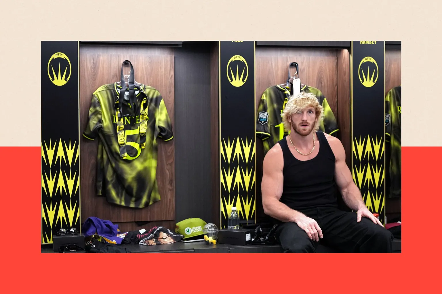 Getty Images Logan Paul, a muscular man with peroxide blonde hair, wearing a black vest while sitting in a locker room