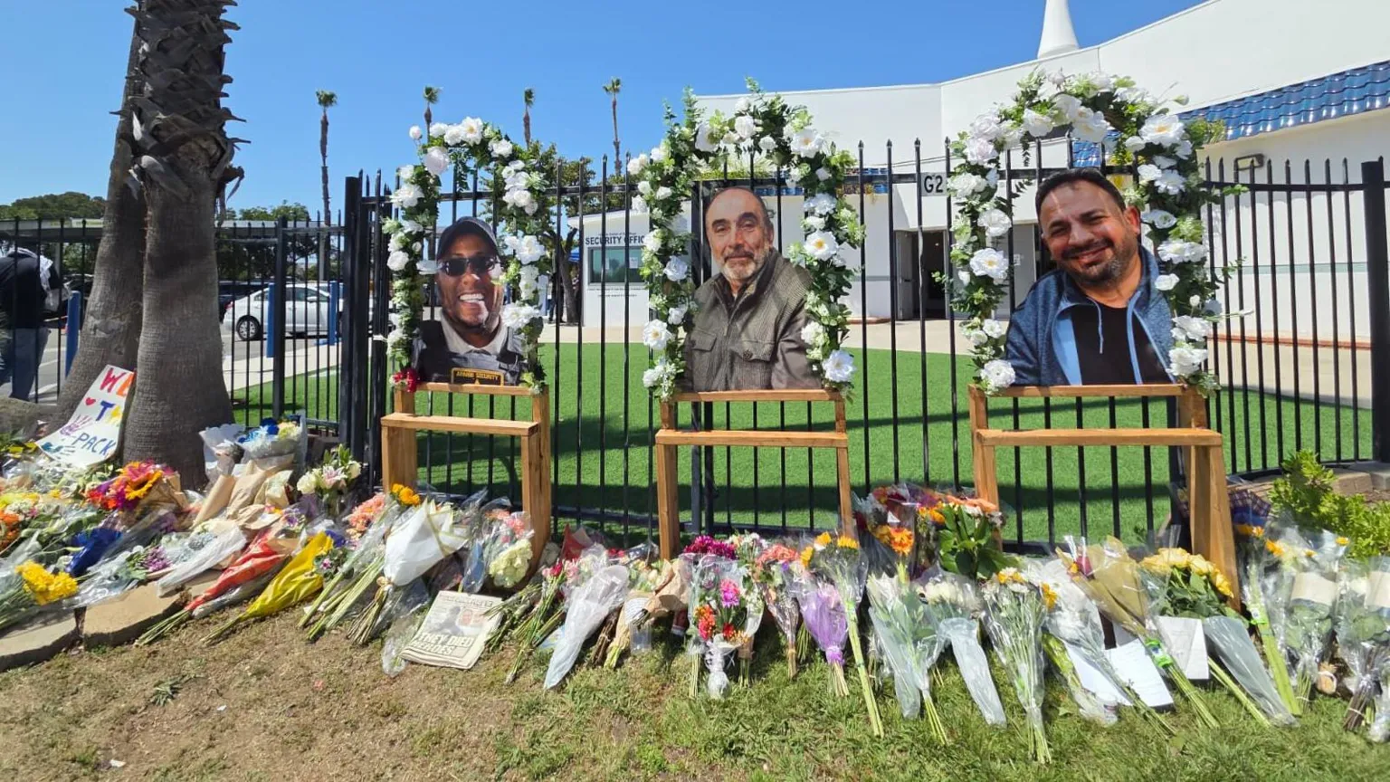 Nardine Saad / BBC Dozens of flower bouquets line the sidewalk outside the fence of the Islamic Center of San Diego, where the images of three victims - Amin Abdullah, Mansuor Kaziha and Nadir Award are placed with flowers around them.